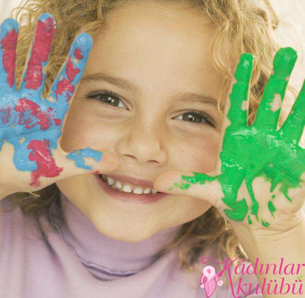 Smiling Girl with Hands Covered in Paint