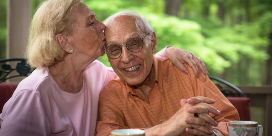 Senior woman kissing man,  smiling