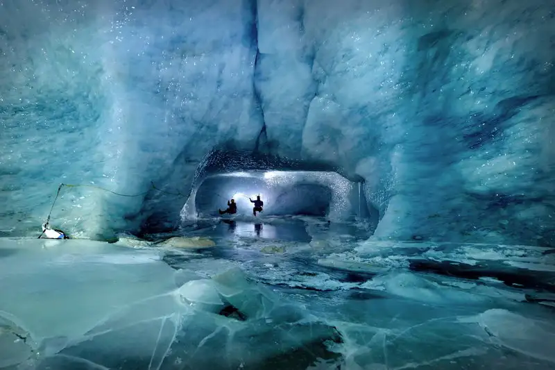 climbing-an-ice-cave-gorner-glacier-switzerland.webp