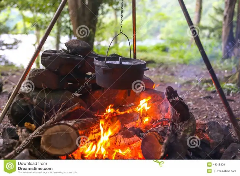 dutch-oven-camp-fire-hung-tripod-over-woods-49018300.webp