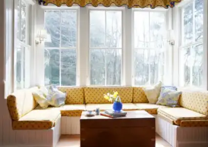 $living-room-bay-window-treatment-yellow.webp