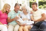 $family-relaxing-together-on-sofa-with-newborn-baby-thumb14926046.jpg