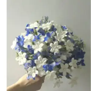 $white-stephanotis-with-blue-wedding-bouquet01.webp