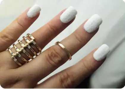 $white velvet manicure and gold ring.webp