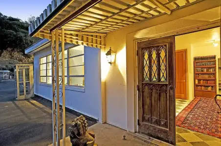 entrance-home-includes-rustic-wooden-doors.webp